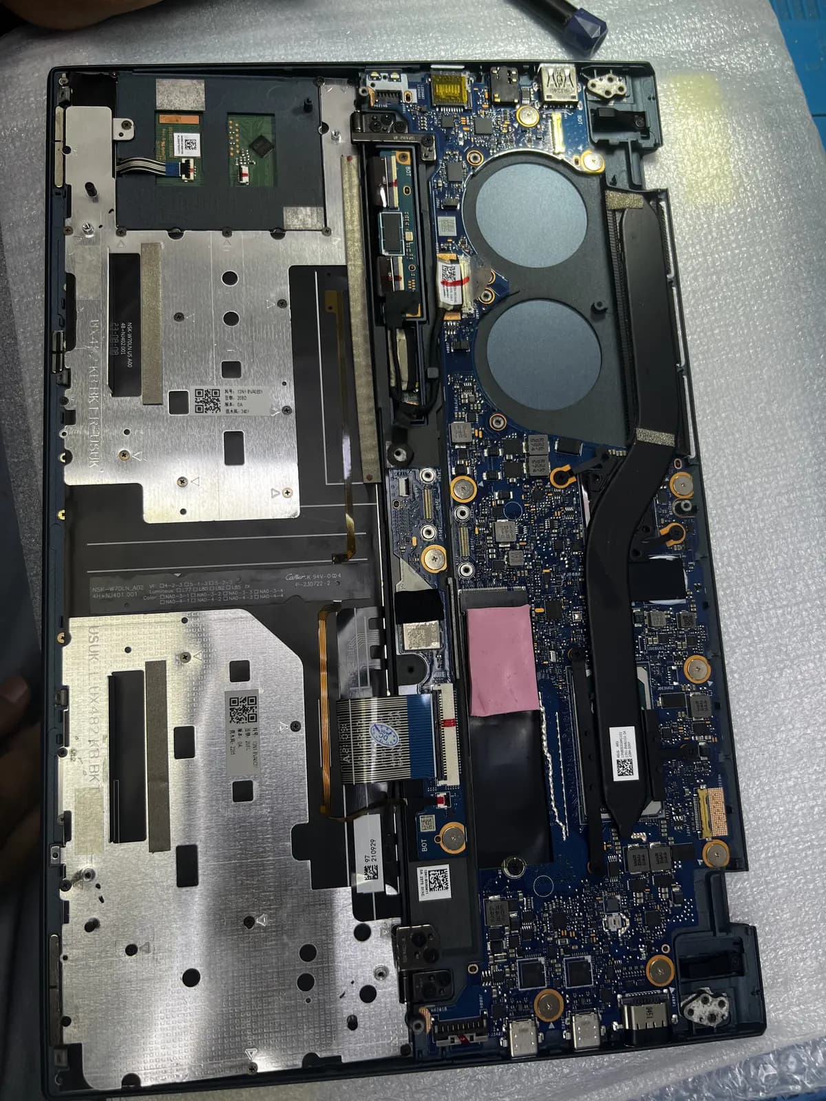 Laptop motherboard removed for chip-level repair